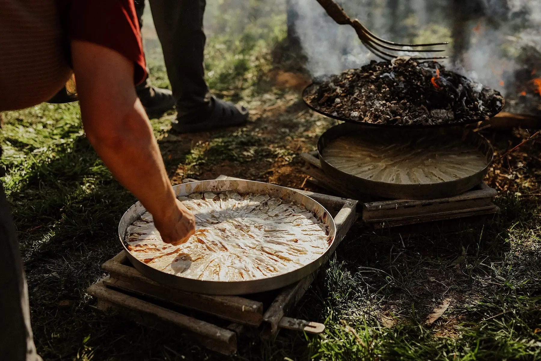 A pie baking under the saç on wood embers, Kruje Albania