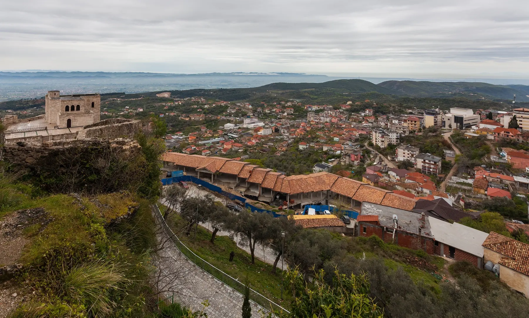 Kruja's rooftops seen from the castle, with the coastal plain where the Shkoder highway runs stretching to the sea, Albania